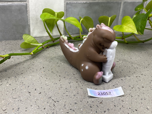 a small ceramic animal sitting next to a plant