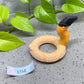a toy snake is on the ground next to a plant