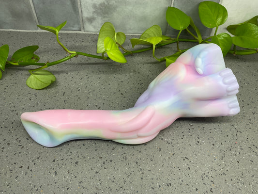 a plastic toy laying on top of a table next to a plant