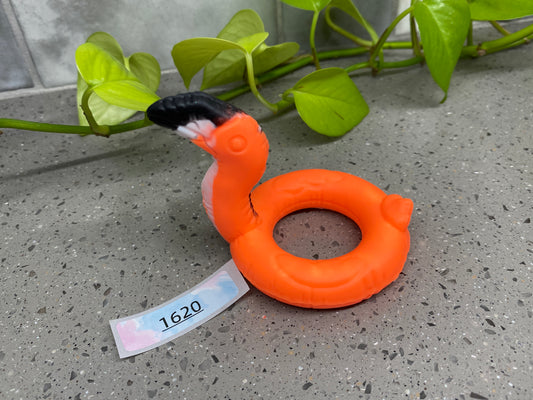 a small orange object with a tag on it