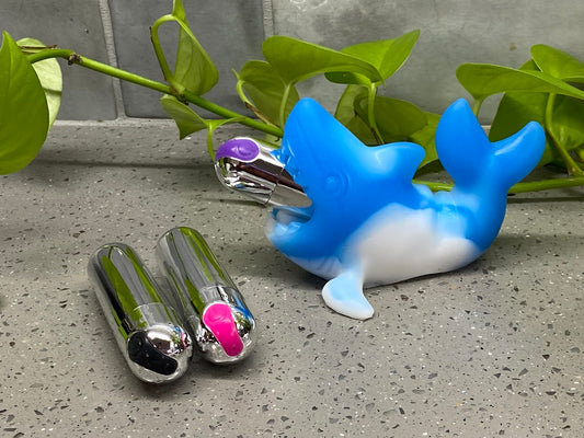 a couple of toothbrush holders sitting on top of a counter