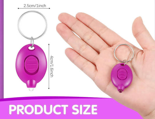 a hand holding a purple plastic key chain