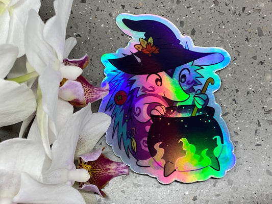 a sticker of a witch holding a cat