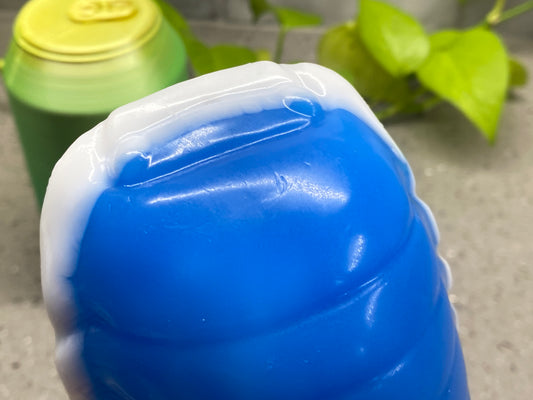 a blue plastic jug sitting next to a green plastic bottle