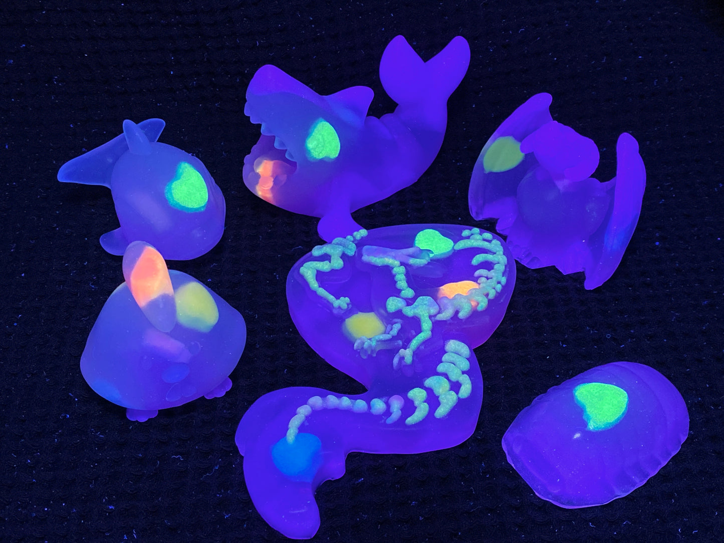 glow in the dark sea creatures on a black background