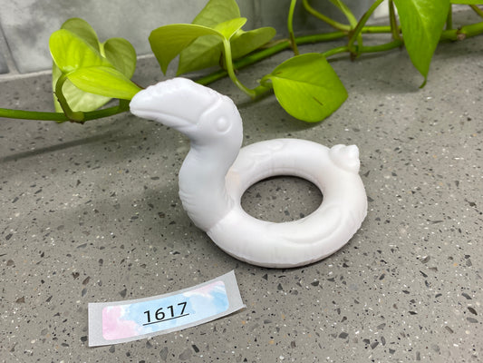 a white rubber ring sitting on top of a table next to a plant