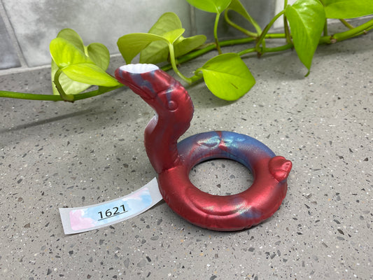 a red and blue ring sitting on top of a cement floor