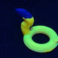 a yellow ring with a blue handle on a black surface