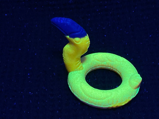 a yellow ring with a blue handle on a black surface