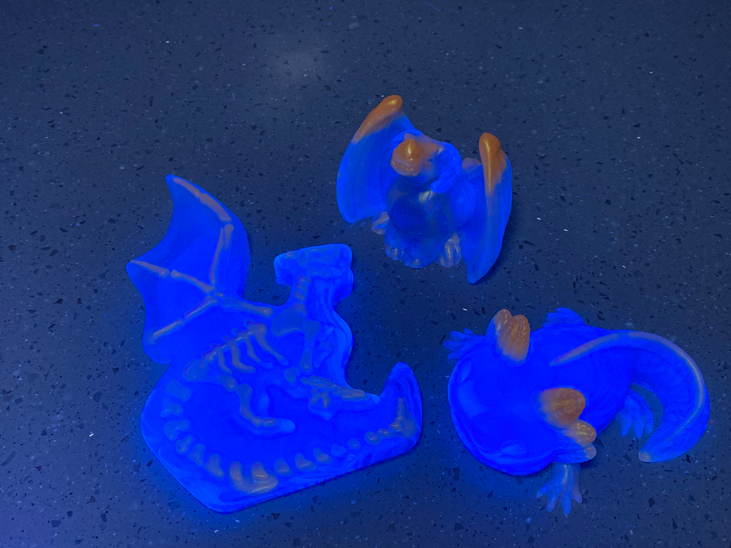three blue plastic toys sitting on top of a table