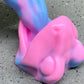 a pink and blue toy laying on the ground