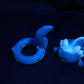 a blue gecko toy sitting on top of a black surface